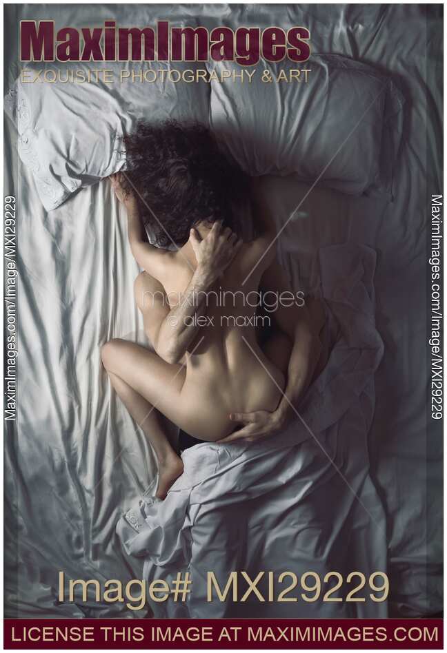 Sexy nude couple making love in bed artistic overhead photo of a woman on top of a man