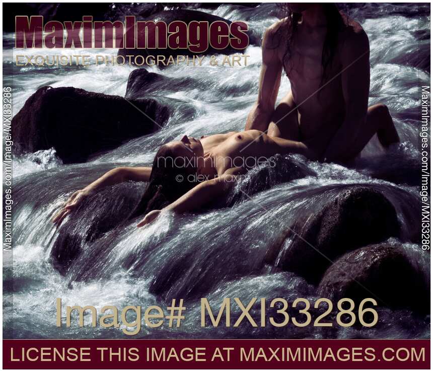 Sexy nude couple making love in wild water of a mountain river stream in beautiful nature scenery