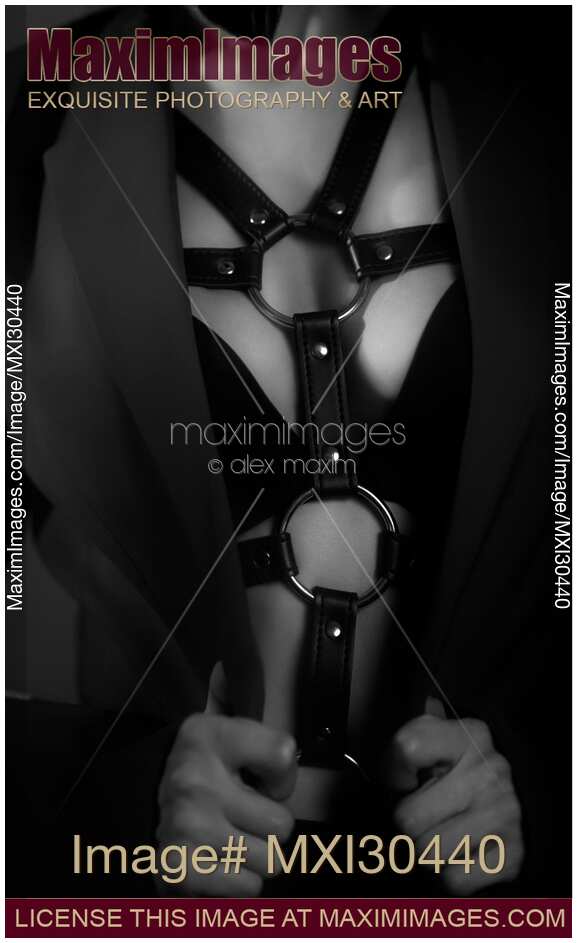 Sexy woman in bondage leather harness and underwear sensual black and white closeup