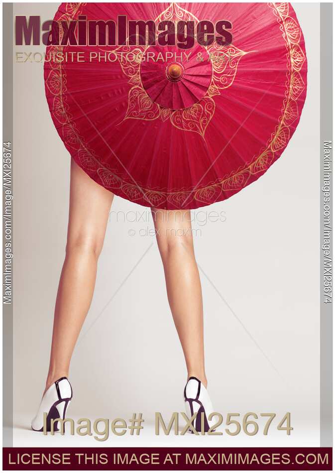 Sexy woman legs behind red Chinese umbrella