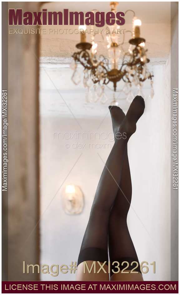 Sexy woman legs in black stockings reflecting in a mirror of a historic house