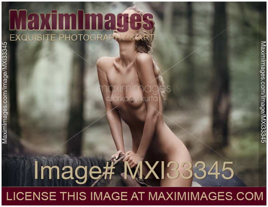 Sexy young blond woman riding a horse naked in forest nature scenery