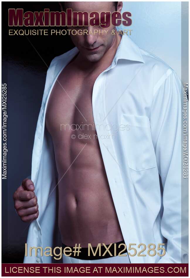 Sexy young man in unbuttoned shirt