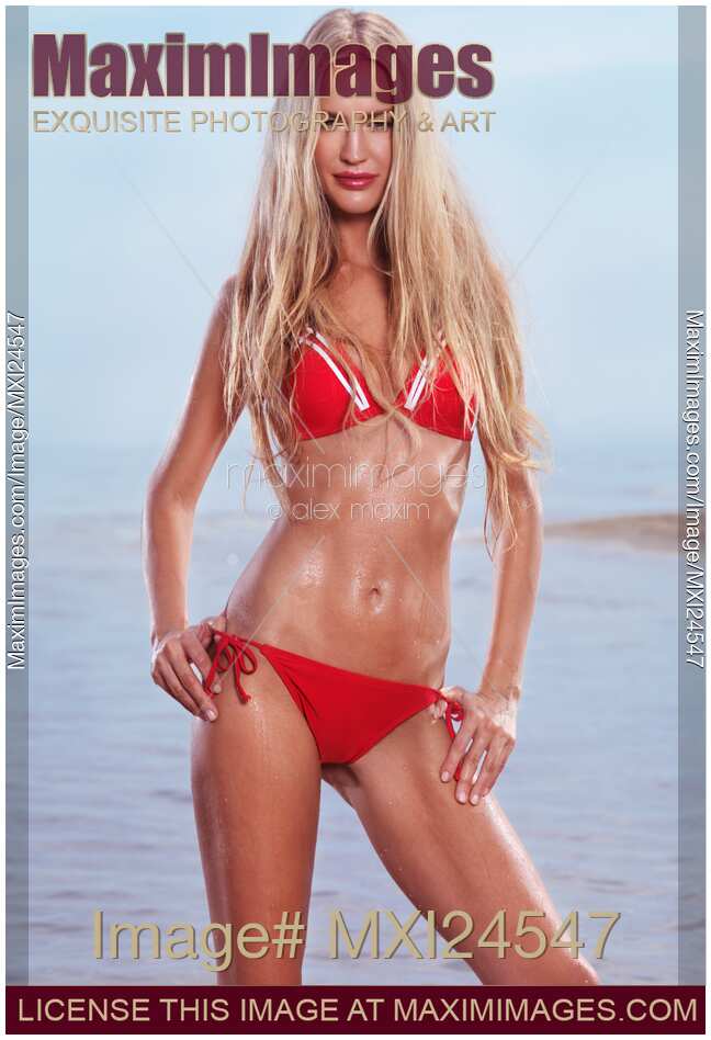 Sexy young woman in red bikini at the beach