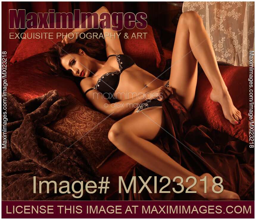 Sexy Young Woman Lying in Bed