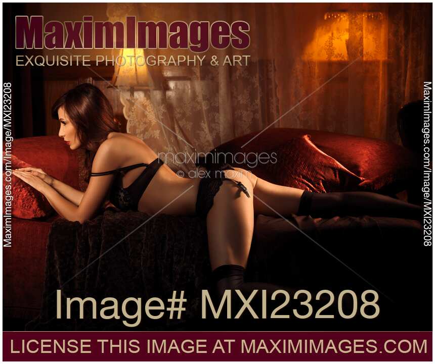 Sexy Young Woman Lying on a Bed