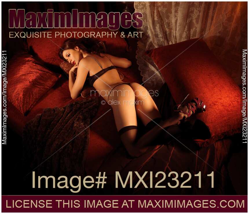 Sexy Young Woman Lying on a Bed