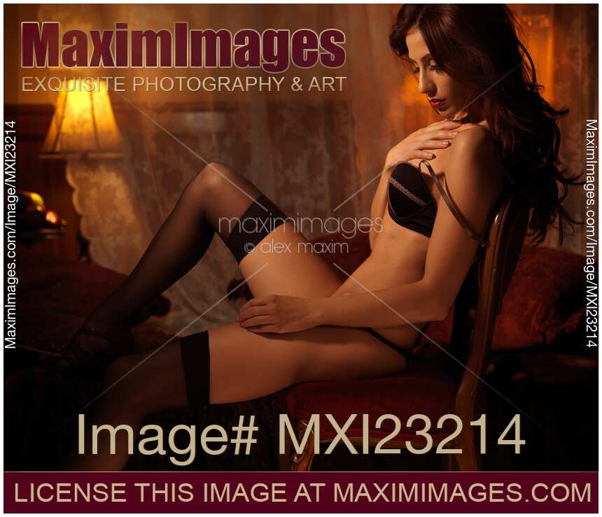 Sexy Young Woman Sitting in a Chair