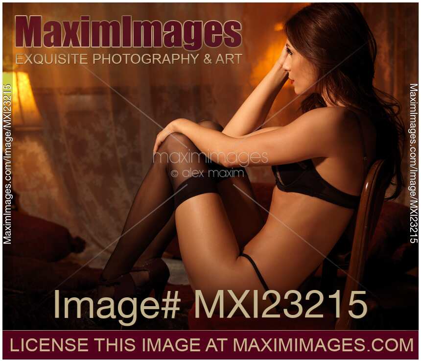 Sexy Young Woman Sitting in a Chair