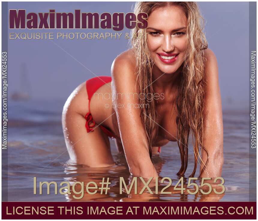 Sexy young woman topless in water