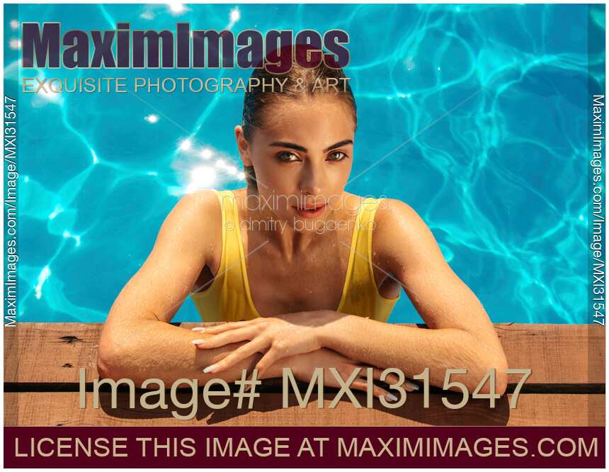 Sexy young woman with an expressing look on the side of a swimming pool