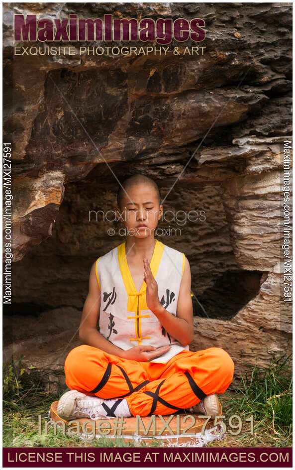 Shaolin martial arts school student meditating under rocks
