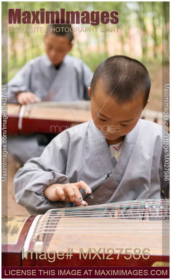 Shaolin martial arts school students playing guzheng