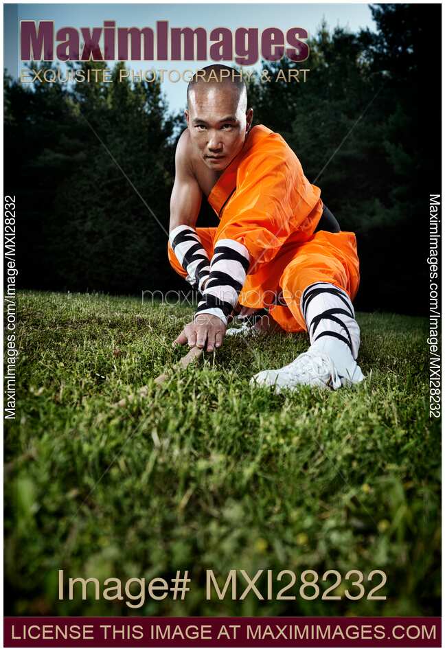 Shaolin warrior monk practicing staff
