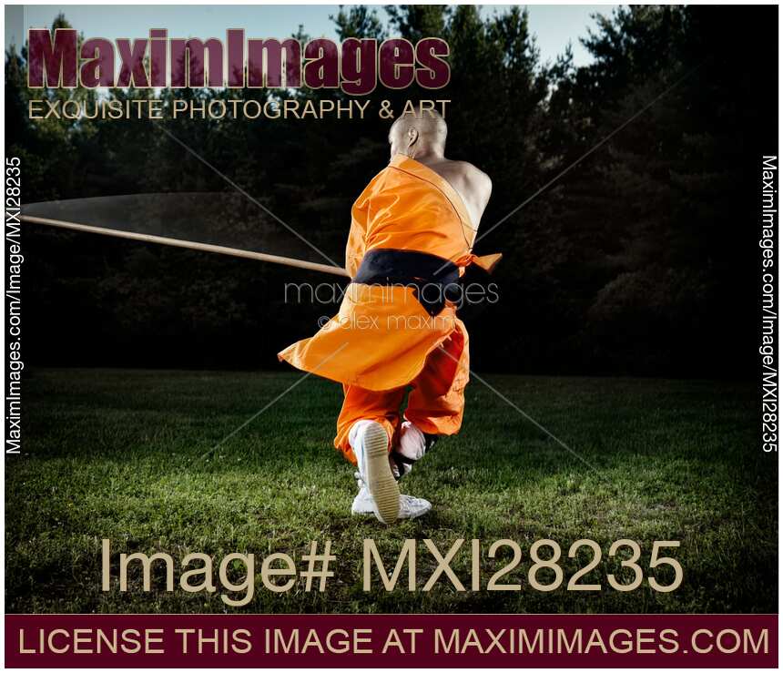 Shaolin warrior monk spinning with a staff