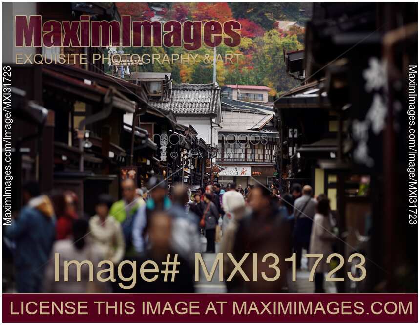 Shops and restaurants at Kami-Sannomachi old town street busy with tourists in Takayama Japan