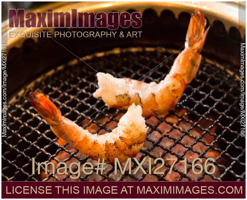 Shrimps being cooked on grill stove
