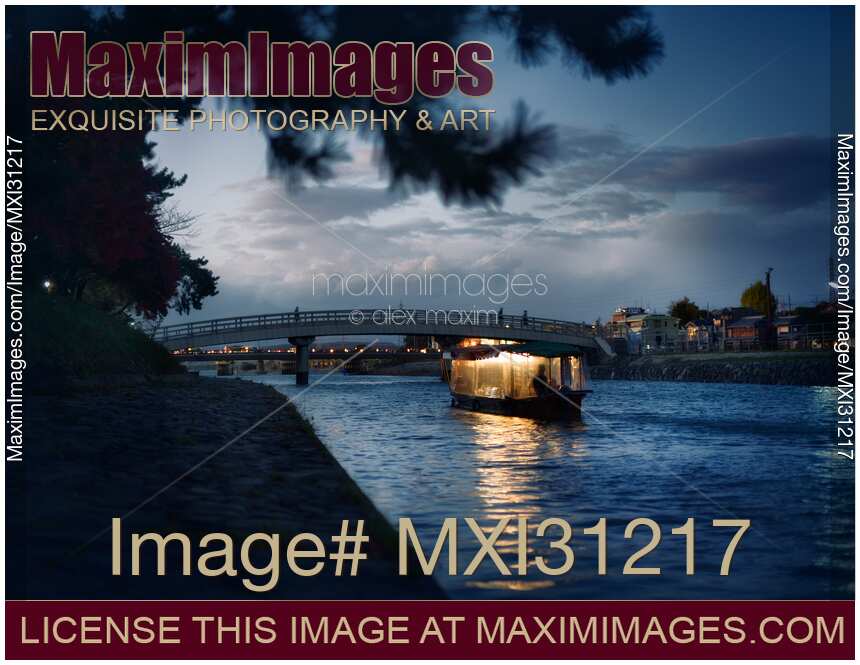 Sightseeing pleasure cruise boat illuminated with lights on Uji River at night