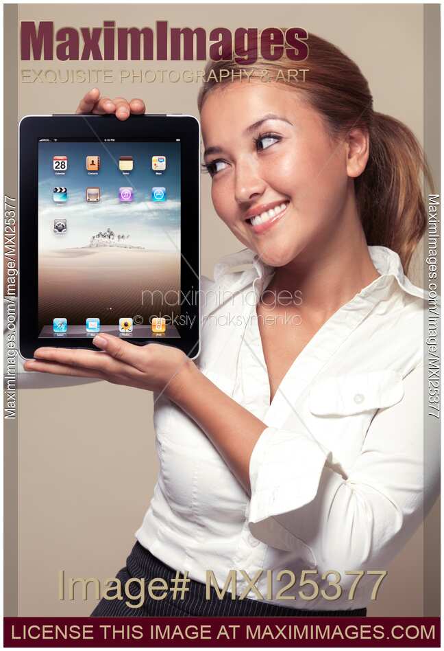 Smiling girl looking at iPad in her hands