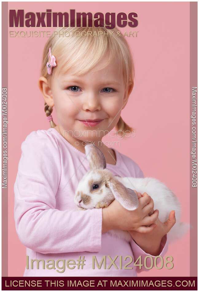 Smiling girl with a bunny in hands