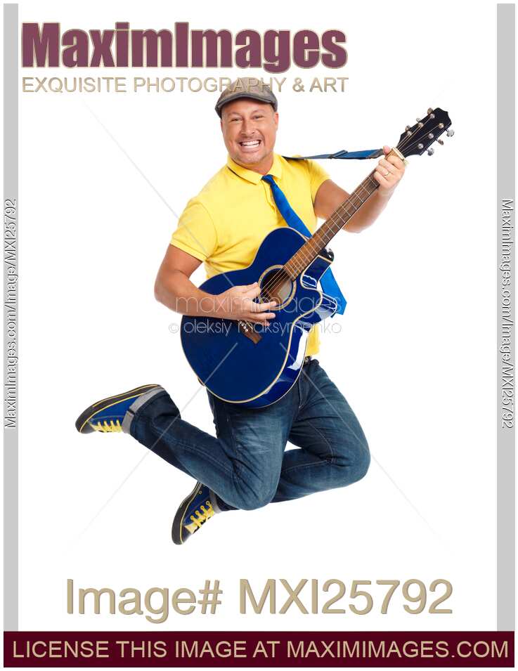 Smiling man with a guitar jumping in the air