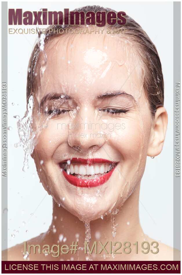 Smiling woman face with red lipstick and dripping water Artistic beauty portrait