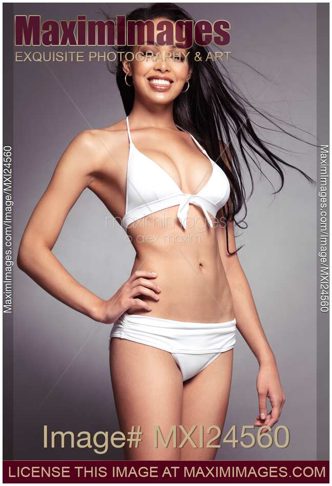 Smiling young black woman in swimsuit