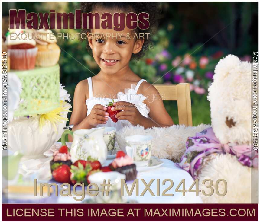 Smiling young girl having a party outdoors