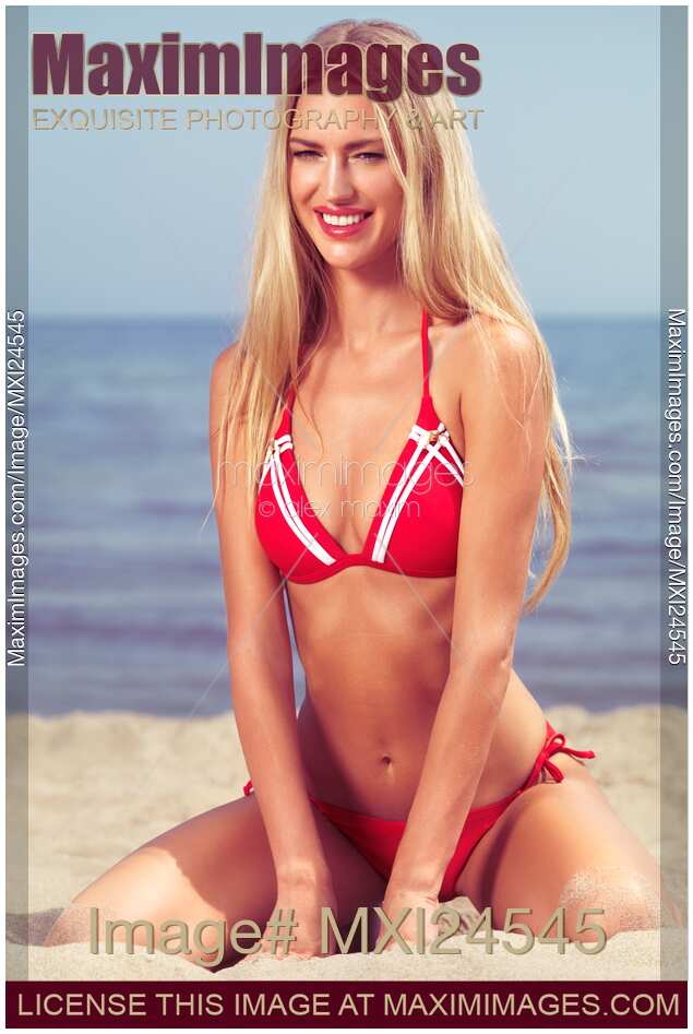 Smiling young woman in red bikini at the beach
