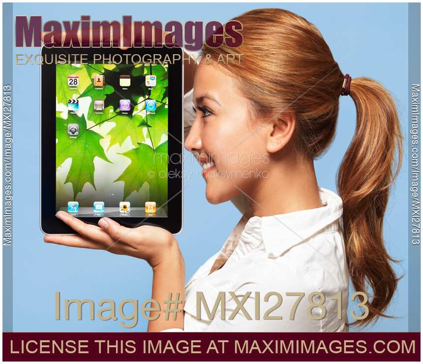 Smiling young woman looking at Apple iPad tablet