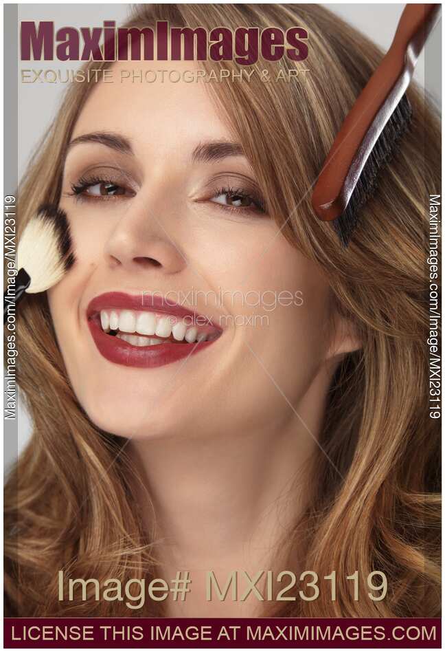 Smiling Young Woman with Her Hair and Makeup Being Done