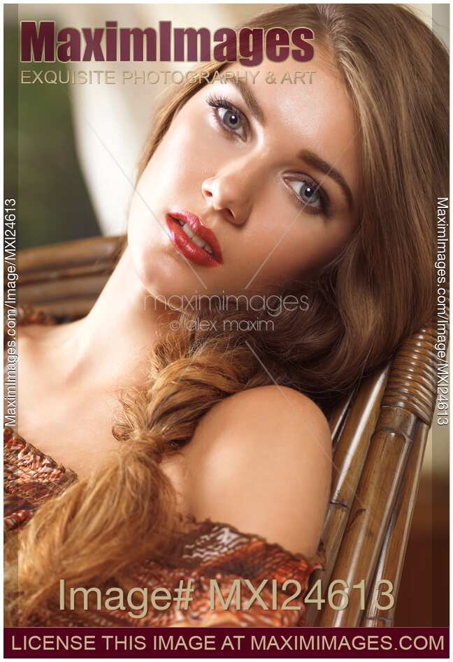 Soft romantic portrait of a young woman in a rocking chair