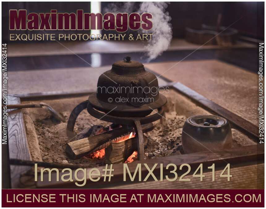 Steaming cast iron kettle Kama on firewood in a Japanese tea house