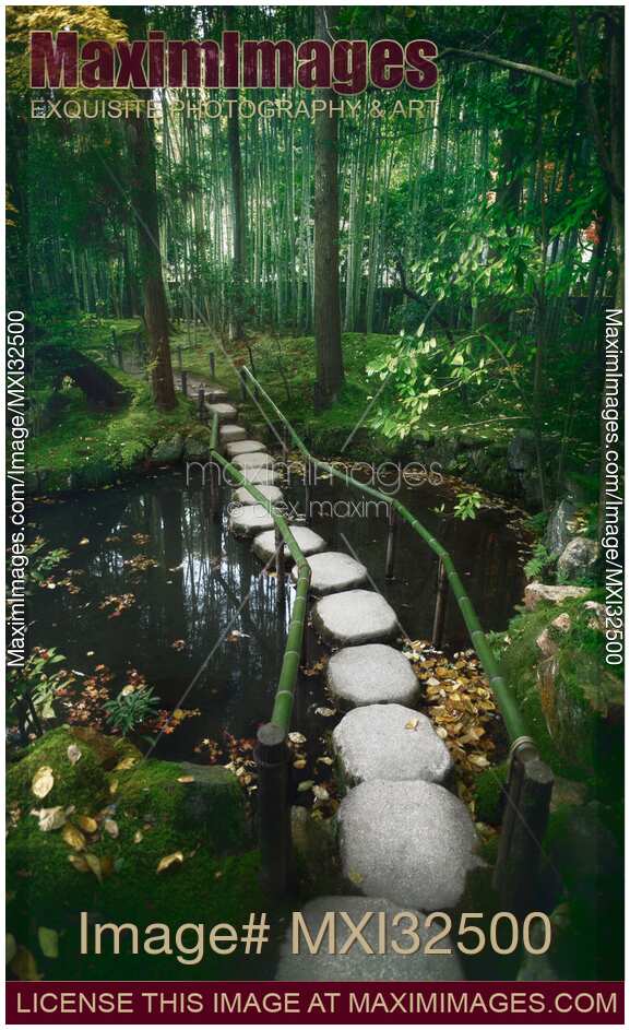 Stepping stones across a pond in a dreamy Japanese Zen garden scenery in Kyoto