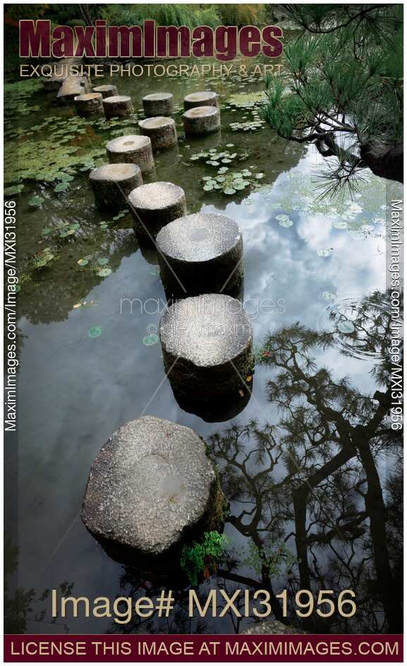 Stepping stones across a pond in Heian-Jingu Shrine gardens. Japanese Zen garden scenery. Heian Jingu Shinto shrine in Sakyo-ku, Kyoto, Japan