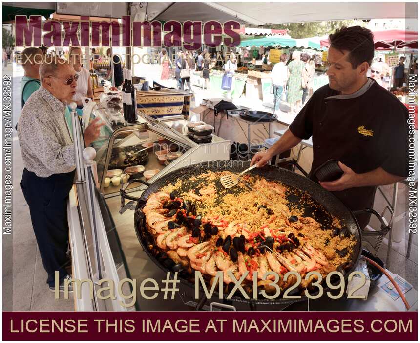 Street food market vendor serving seafood Paella in Aix-en-Provence France