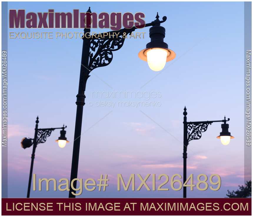 Street lamps over sunset sky background