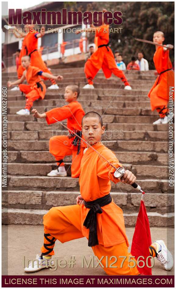 Students of Shaolin Kung Fu school performing with weapons in DengFeng