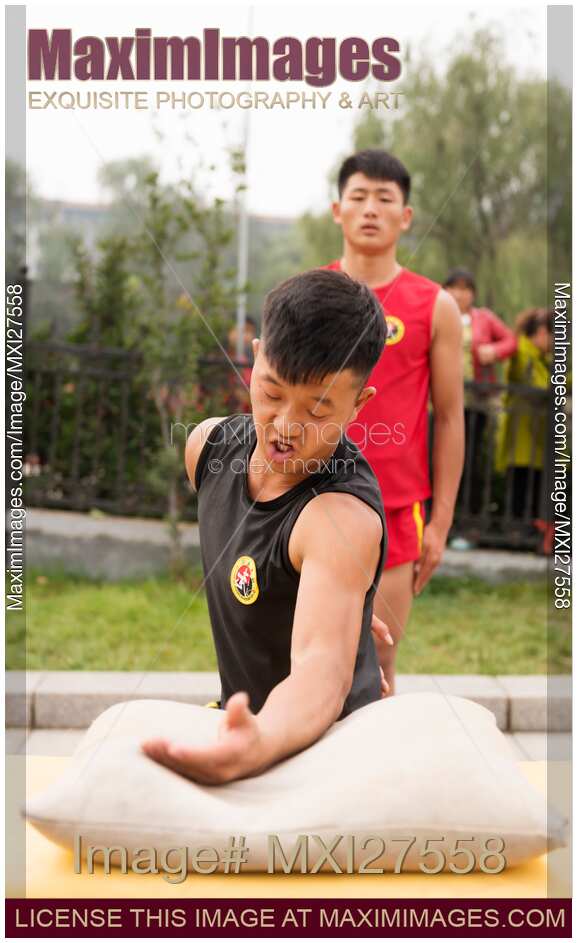 Students of Shaolin martial arts school conditioning their hands