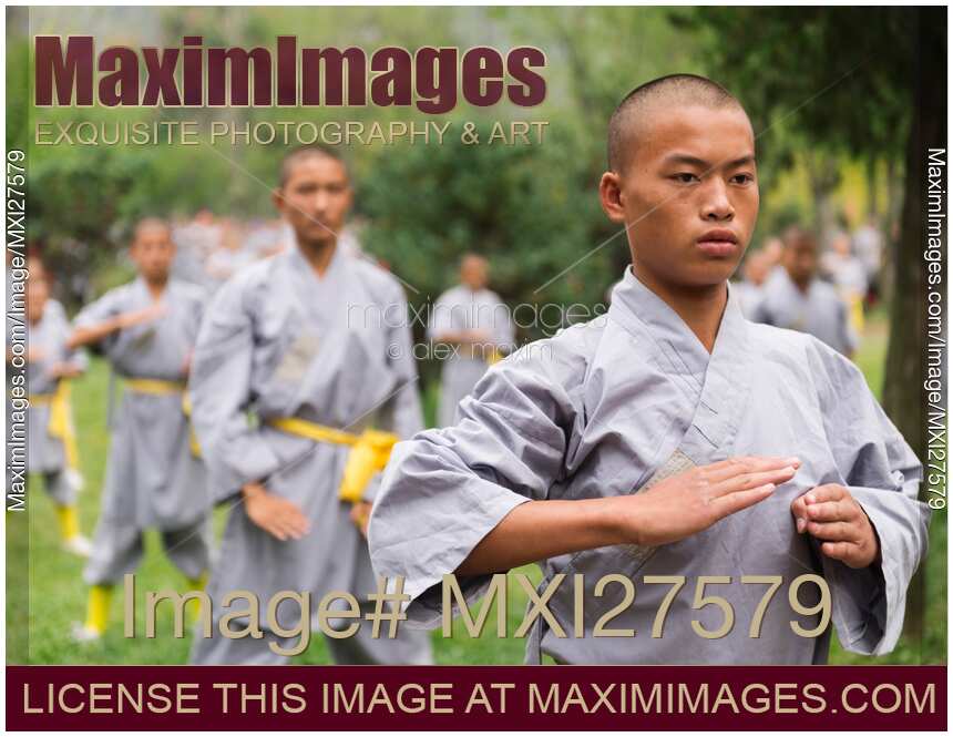 Students of Shaolin martial arts school practicing Qi Gong outside