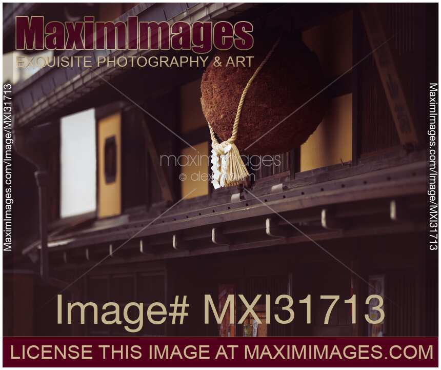 Sugidama aged cedar orb with Shimenawa rope hanging above entrance of a Sake Brewery in Takayama Japan