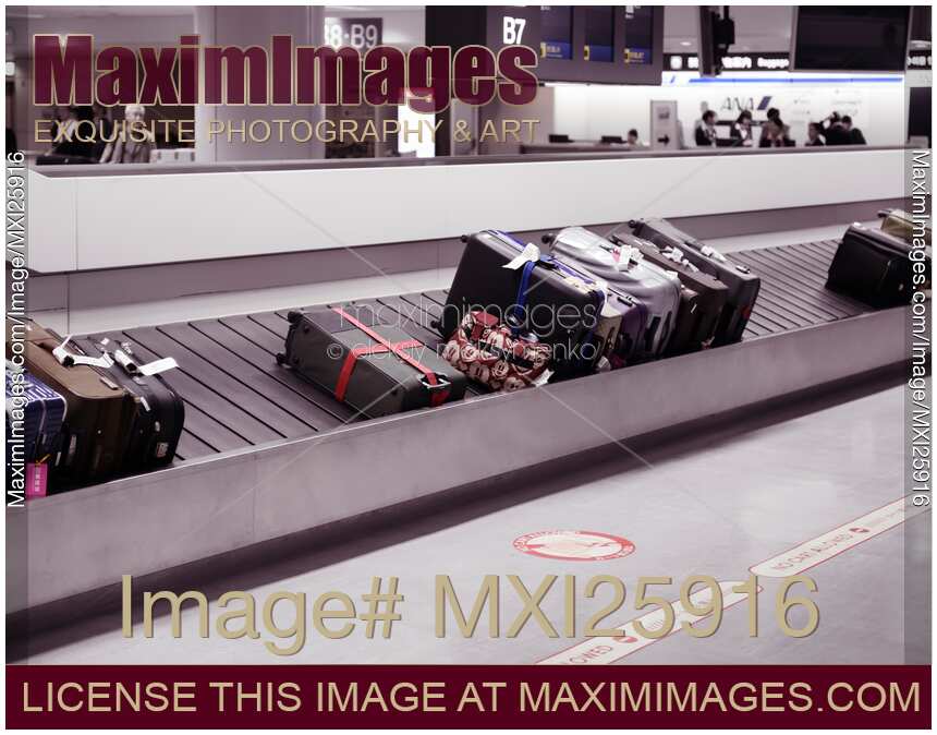 Suitcases on airport baggage claim conveyor
