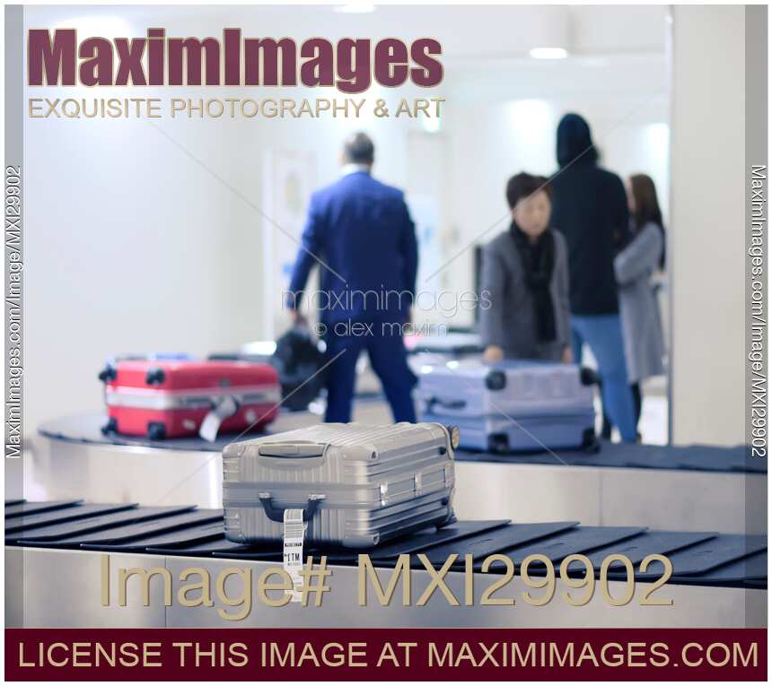 Suitcases on airport baggage claim conveyor
