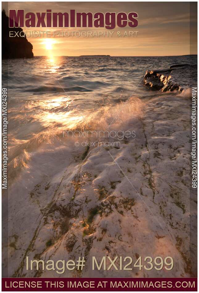 Sunset nature scenery of waves hitting rocky shore