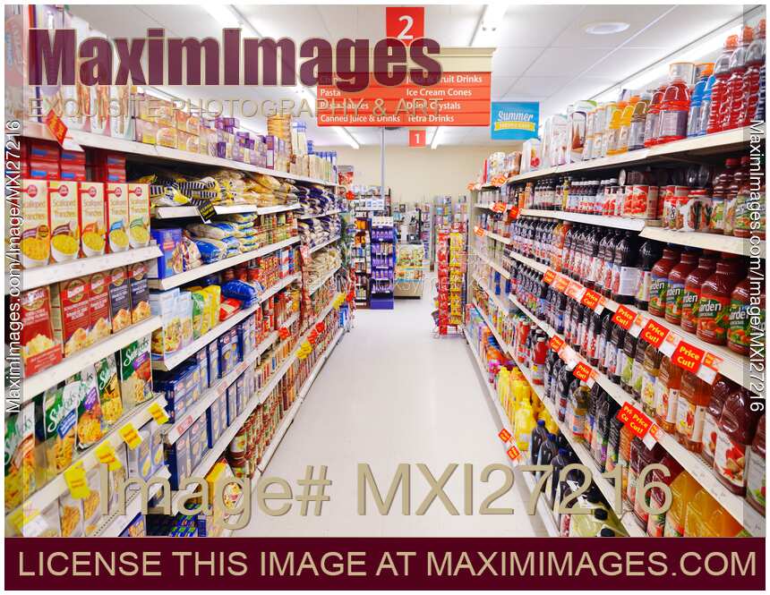 Supermarket aisle with grocery products on the shelves