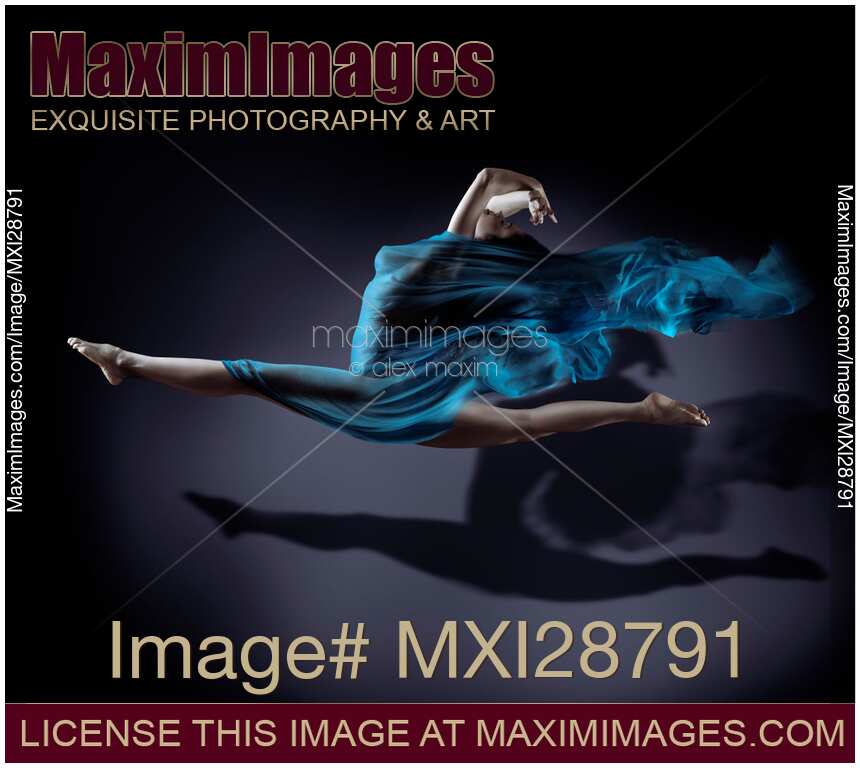 Surreal portrait of woman jumping with her legs in splits with flowing cloth wrapped around her nude body