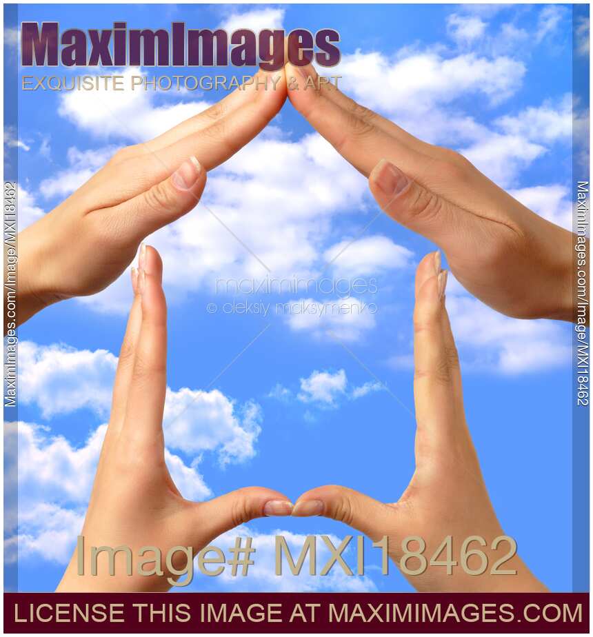 Symbol home made by hands over blue sky