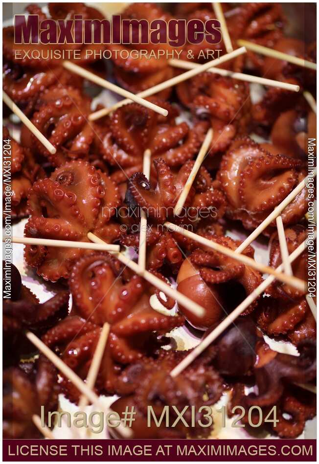Tako tamago grilled baby octopus at food market stall in Japan