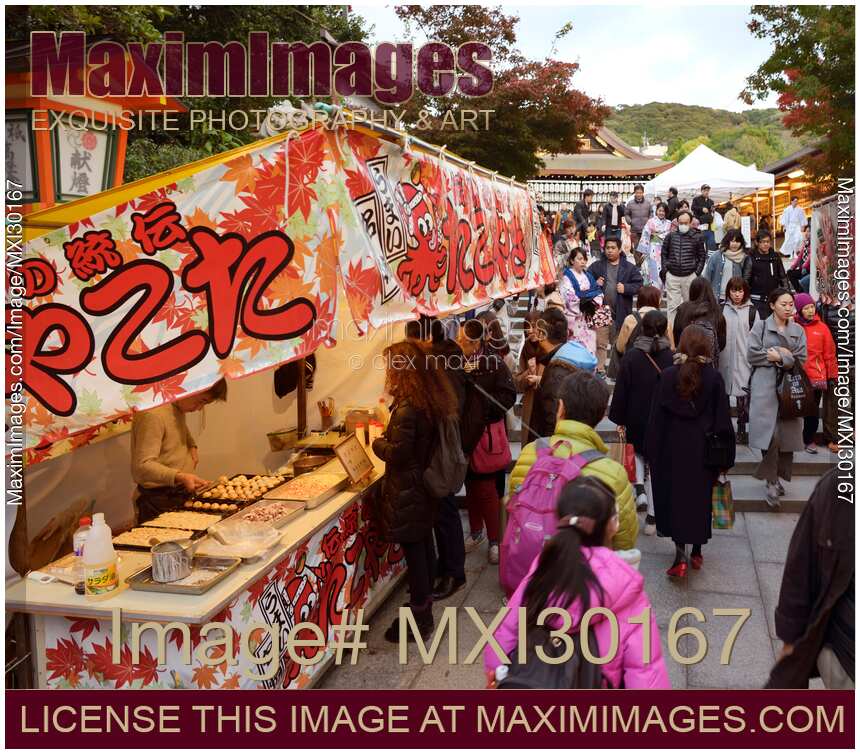 Takoyaki grilled octopus food stand at a street food market in Kyoto Japan