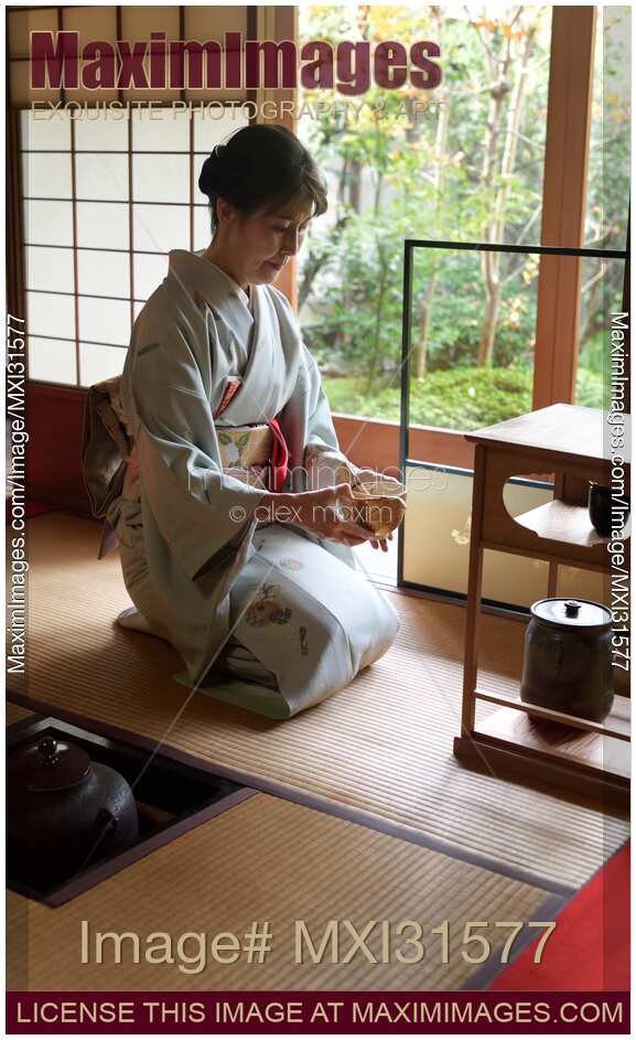 Tea ceremony master serving matcha tea in a bowl in a traditional Japanese tea house